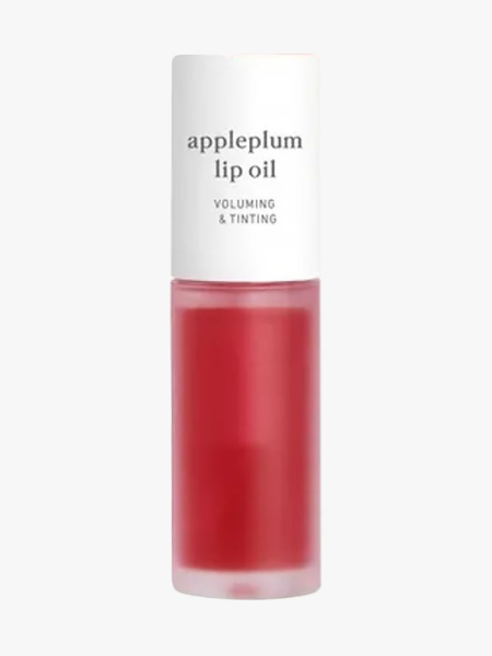Noonie Appleplum Lip Oil in branded component on a light gray background